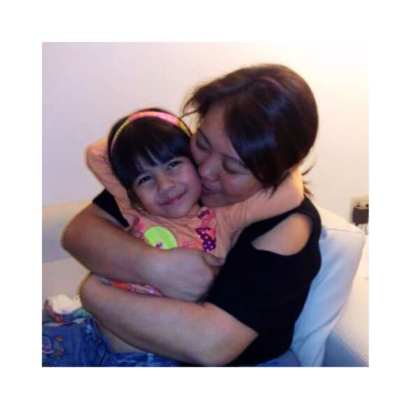 Jeane Satie embracing daughter Aisha at age 3, representing maternal lineage and the unbroken chain of mitochondrial DNA passed from mother to daughter